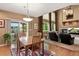 View of the open floor plan, which features a living room, dining room, fireplace, and access to a patio at 15962 W 70Th Dr, Arvada, CO 80007