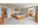 Cozy main bedroom with neutral tones and an adjacent bathroom and second story overlook at 15962 W 70Th Dr, Arvada, CO 80007