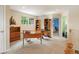 Bright office with wood desk, shelving, and natural light from the window at 15962 W 70Th Dr, Arvada, CO 80007