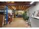 Unfinished basement with storage and utility areas, including boxes and shelving at 15962 W 70Th Dr, Arvada, CO 80007