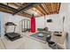 Spacious basement transformed into a home gym with a treadmill, weights, and a heavy punching bag at 14431 Forest St, Thornton, CO 80602