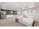 Basement features a wet bar with stainless fridge and a rec room with white sectional sofa at 14431 Forest St, Thornton, CO 80602