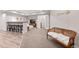 This basement features a wet bar with seating and an adjacent rec room with decorative bench at 14431 Forest St, Thornton, CO 80602