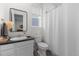 This well-lit bathroom features a modern vanity and a classic shower and toilet at 14431 Forest St, Thornton, CO 80602