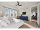Bright bedroom features a large bed, carpet flooring, tray ceiling, dresser, and view into the living room at 14431 Forest St, Thornton, CO 80602