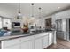 Spacious kitchen island featuring stainless steel appliances, pendant lighting and modern finishes at 14431 Forest St, Thornton, CO 80602