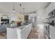 Modern kitchen featuring a large island, stainless steel appliances, and an open floor plan at 14431 Forest St, Thornton, CO 80602