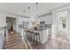 Modern kitchen featuring granite counters, stainless appliances, and a spacious island with seating at 14431 Forest St, Thornton, CO 80602