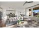 Open concept living room showcasing natural light, a modern couch, and an adjoining kitchen at 14431 Forest St, Thornton, CO 80602