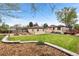 A large backyard with mature trees, a wooden deck, patio, and a garden area at 3000 N Fillmore St, Denver, CO 80205