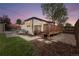 Backyard with patio and modern furniture, connected to wooden deck and grassy area at 3000 N Fillmore St, Denver, CO 80205