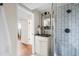 Modern bathroom with black countertop, stylish fixtures, and a tiled shower with glass door at 3000 N Fillmore St, Denver, CO 80205
