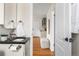 Bathroom vanity with black countertop and view into hallway with hardwood floors at 3000 N Fillmore St, Denver, CO 80205