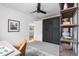 Open bedroom featuring a murphy bed, black trim, and shelving at 3000 N Fillmore St, Denver, CO 80205
