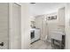 Bright laundry room with tile floors, utility sink, and modern washer and dryer set at 3000 N Fillmore St, Denver, CO 80205