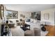 Spacious living room with hardwood floors, a large sofa, and access to the kitchen at 3000 N Fillmore St, Denver, CO 80205