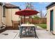Outdoor dining set with a large red umbrella offering shade and comfort at 3000 N Fillmore St, Denver, CO 80205