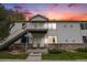 Inviting townhome exterior with stairway to the 2nd story entrance and well-maintained front lawn at 18038 Becket Dr, Parker, CO 80134