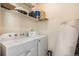 Laundry room with washer, dryer, and shelving for storage at 18038 Becket Dr, Parker, CO 80134