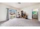 Spacious, carpeted living room with a sliding glass door, closet, and access to a bathroom at 18038 Becket Dr, Parker, CO 80134