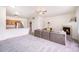 Spacious living room with a fireplace, ceiling fan, and view to the kitchen area at 18038 Becket Dr, Parker, CO 80134