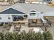 Aerial showcasing an outdoor kitchen, dining, hot tub, a fire pit area, and lush landscaping at 11177 E 162Nd Pl, Brighton, CO 80602