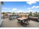 Inviting back deck with a custom bar, outdoor dining, and serene neighborhood views at 11177 E 162Nd Pl, Brighton, CO 80602