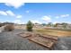 Large backyard with garden beds, stone landscaping, and a charming white fence at 11177 E 162Nd Pl, Brighton, CO 80602