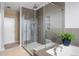 Bright bathroom with a glass shower and soaking tub with tiled walls at 11177 E 162Nd Pl, Brighton, CO 80602