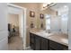 Well-lit bathroom featuring a vanity, mirror, and access to a bedroom at 11177 E 162Nd Pl, Brighton, CO 80602