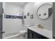 Updated bathroom with walk-in shower, modern fixtures, and designer tile work at 11177 E 162Nd Pl, Brighton, CO 80602