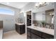 Contemporary bathroom with dual vanities, spacious layout, and walk-in closet at 11177 E 162Nd Pl, Brighton, CO 80602