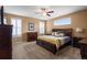 Large bedroom with hardwood floors, ceiling fan, and dresser at 11177 E 162Nd Pl, Brighton, CO 80602