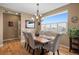 Bright dining room featuring hardwood floors, a chandelier, and window with plantation shutters at 11177 E 162Nd Pl, Brighton, CO 80602