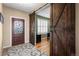 Elegant foyer features decorative glass door, stylish barn door, and beautiful hardwood floors at 11177 E 162Nd Pl, Brighton, CO 80602