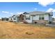 Attractive home featuring stone accents, blue siding, and manicured landscaping at 11177 E 162Nd Pl, Brighton, CO 80602