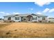 Charming single story home featuring stone accents, blue siding, and a covered front porch at 11177 E 162Nd Pl, Brighton, CO 80602