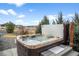 Relaxing hot tub with easy access steps, privacy fence, and a view of the backyard landscaping at 11177 E 162Nd Pl, Brighton, CO 80602