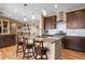 Open-concept kitchen featuring stainless steel appliances, granite countertops, and counter seating at 11177 E 162Nd Pl, Brighton, CO 80602