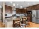 Eat-in kitchen featuring stainless steel appliances, granite countertops, and dark wood cabinetry at 11177 E 162Nd Pl, Brighton, CO 80602