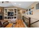 Open living room with fireplace, hardwood floors and stairs leading upstairs at 11177 E 162Nd Pl, Brighton, CO 80602