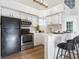 Bright kitchen featuring white cabinets, stainless steel appliances, and bar seating at 11195 Alcott St # D, Westminster, CO 80234