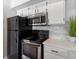 Close-up of the kitchen with stainless steel appliances and a tiled backsplash at 11195 Alcott St # D, Westminster, CO 80234