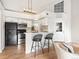 Bright kitchen with white cabinets, stainless steel appliances, and barstool seating at 11195 Alcott St # D, Westminster, CO 80234