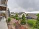 Landscaped backyard with fencing, river rock, shrubs, and a view of the neighborhood at 7845 S Flat Rock Way, Aurora, CO 80016