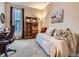 Cozy bedroom featuring a daybed, carpet, and ample natural light from the nearby window at 7845 S Flat Rock Way, Aurora, CO 80016