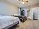 Bedroom featuring two beds, carpet, ceiling fan, and an adjacent doorway at 7845 S Flat Rock Way, Aurora, CO 80016