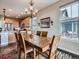 Dining room with a wood table and chairs adjacent to kitchen featuring natural light at 7845 S Flat Rock Way, Aurora, CO 80016