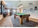 Spacious game room featuring a pool table, wet bar, and adjacent seating area with views at 7845 S Flat Rock Way, Aurora, CO 80016