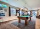 Entertaining game room with pool table, ambient lighting, and views of the backyard at 7845 S Flat Rock Way, Aurora, CO 80016